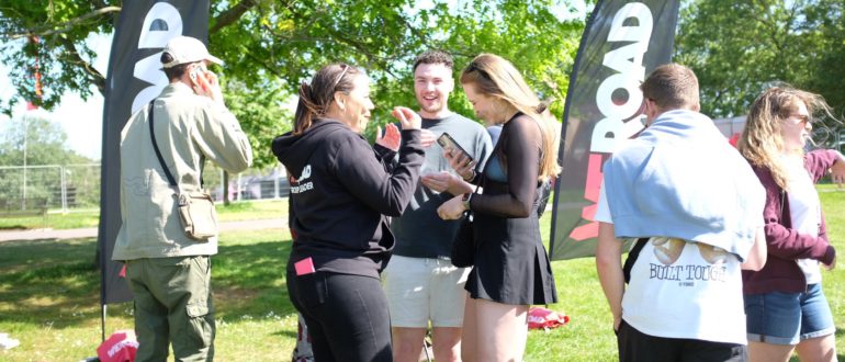 Group of people enjoying talking to a Brand Ambassador at a festival in Brockwell Park, London